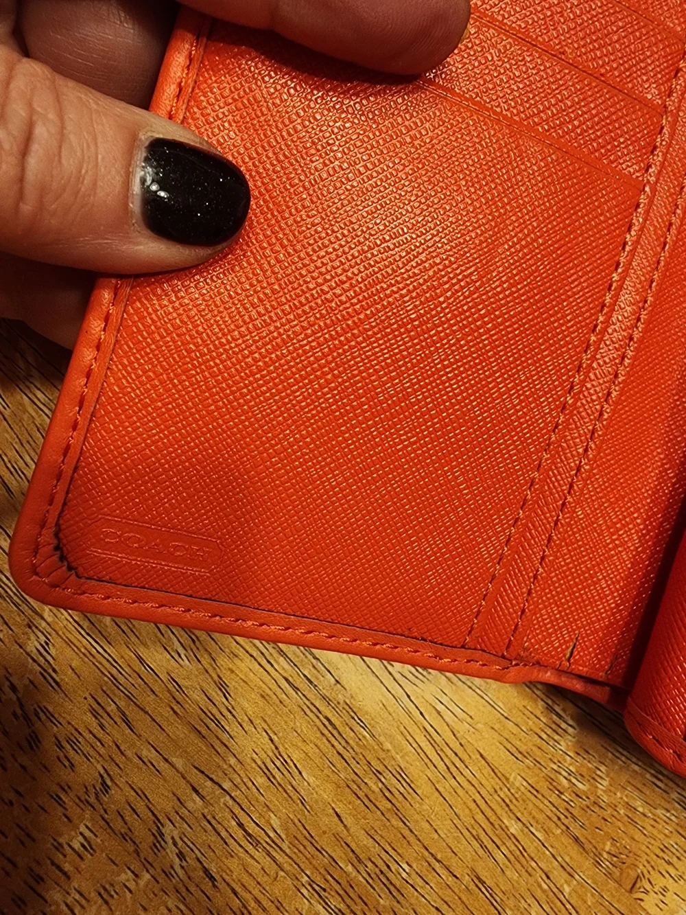 Coach Campbell Leather Buckle Medium Wallet in a vibrant orange shade with brass